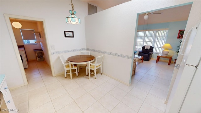 dining room featuring visible vents, light tile patterned flooring, ceiling fan, washer / dryer, and baseboards