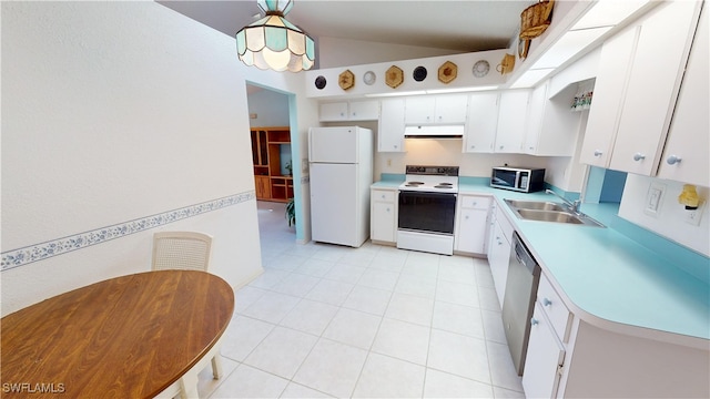 kitchen featuring lofted ceiling, under cabinet range hood, a sink, light countertops, and appliances with stainless steel finishes