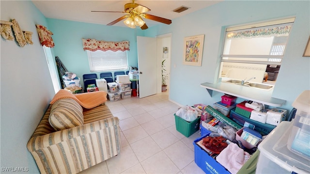 interior space featuring ceiling fan, visible vents, and tile patterned floors