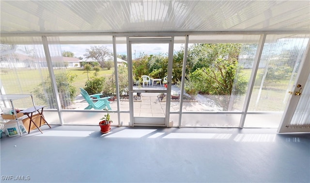 doorway to outside with a sunroom and finished concrete floors