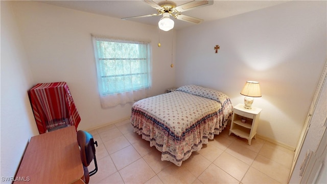 bedroom featuring baseboards, a ceiling fan, and light tile patterned flooring