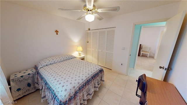 bedroom featuring a ceiling fan, a closet, and light tile patterned flooring