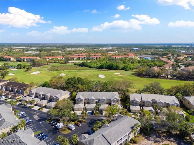 birds eye view of property with view of golf course and a residential view