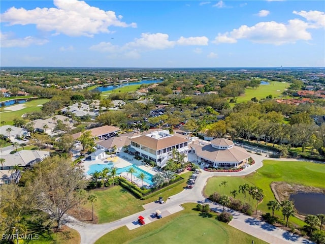 aerial view with golf course view and a water view