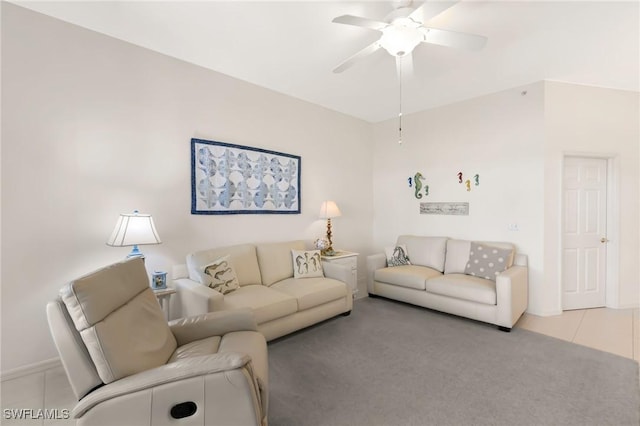 living room featuring light tile patterned flooring, a ceiling fan, and light colored carpet