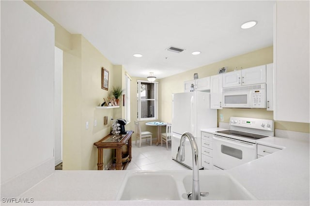 kitchen featuring white appliances, visible vents, light countertops, white cabinetry, and recessed lighting