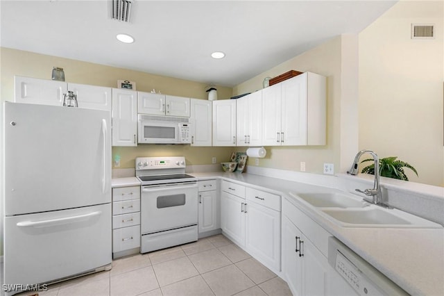 kitchen with white appliances, visible vents, a sink, and light tile patterned floors