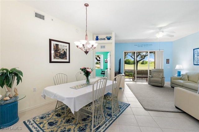 dining area with ceiling fan with notable chandelier, light tile patterned flooring, visible vents, and baseboards