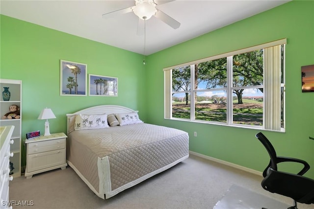 bedroom featuring baseboards, a ceiling fan, and light colored carpet