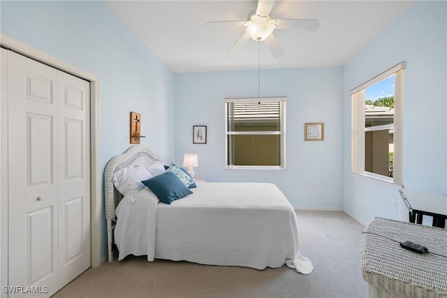 bedroom with baseboards, a ceiling fan, and light colored carpet