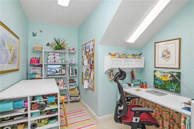 office space featuring vaulted ceiling and baseboards