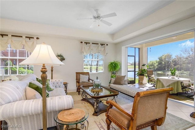 living area featuring ceiling fan and tile patterned floors