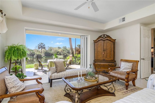 sitting room with visible vents, ceiling fan, and light tile patterned flooring