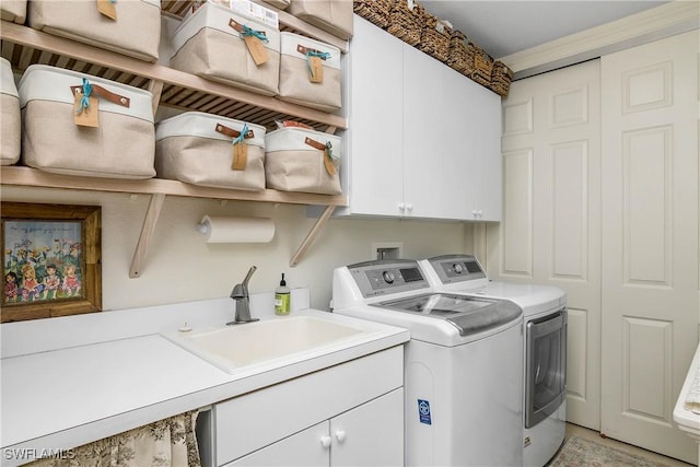 laundry room featuring a sink, cabinet space, and washer and dryer