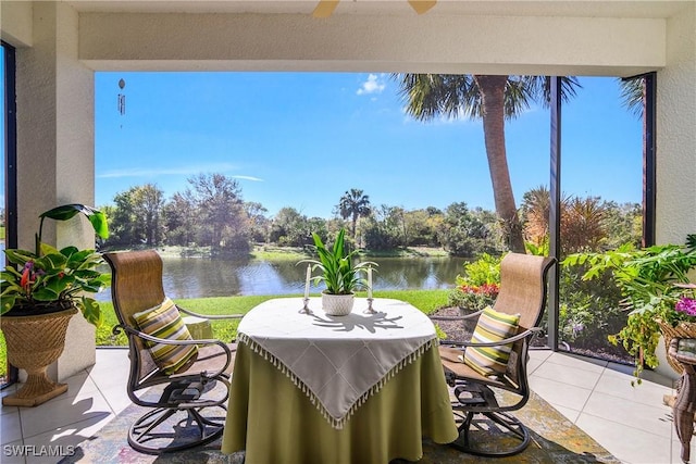 view of patio / terrace featuring a water view and a ceiling fan