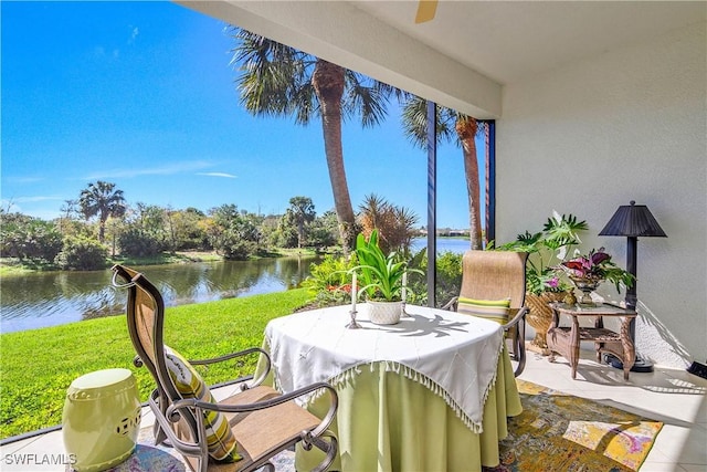 sunroom / solarium with a water view