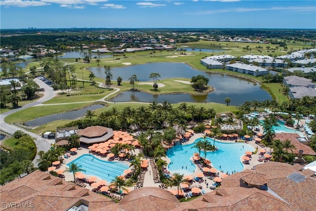 drone / aerial view featuring golf course view and a water view