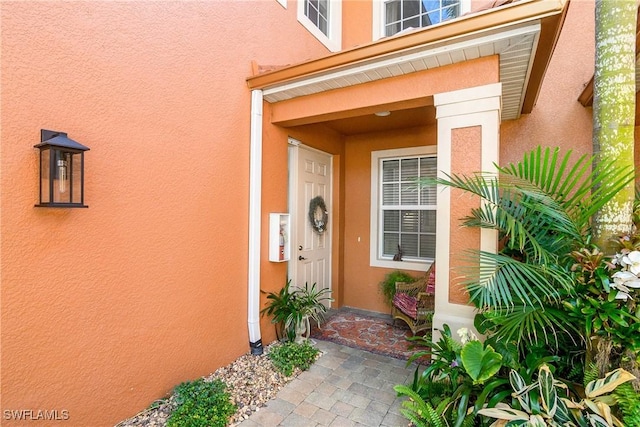 property entrance with stucco siding