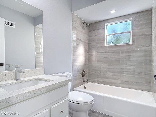 full bath with toilet, visible vents,  shower combination, and vanity