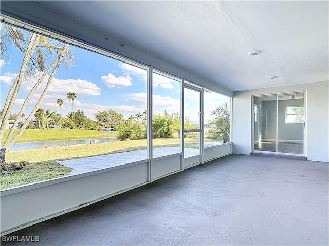 unfurnished sunroom with a water view