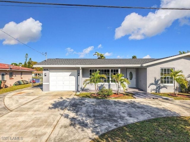 ranch-style home featuring a garage, driveway, and stucco siding