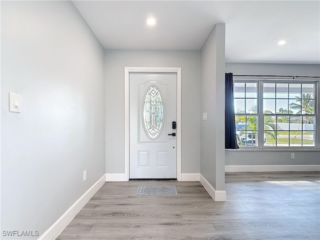 entrance foyer featuring baseboards, wood finished floors, and recessed lighting