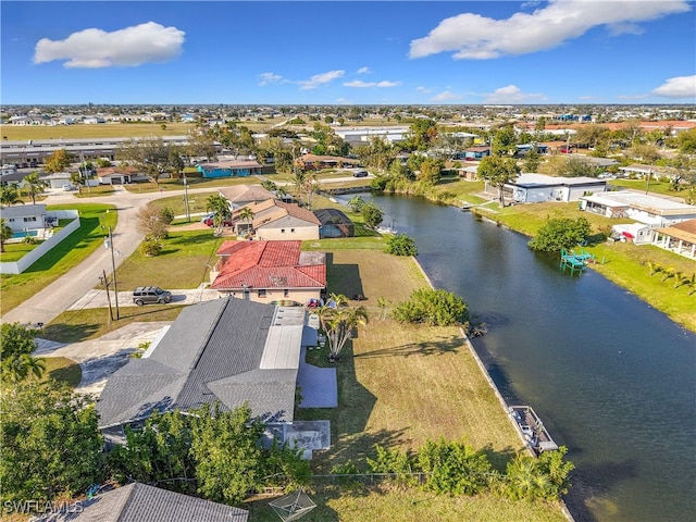 drone / aerial view featuring a water view and a residential view