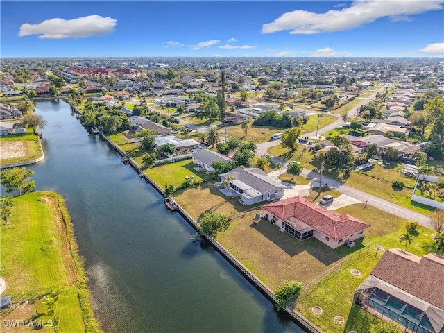 birds eye view of property with a water view and a residential view