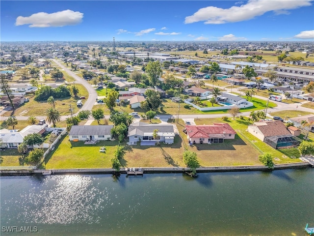 drone / aerial view with a water view and a residential view