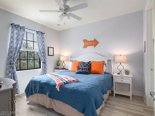 bedroom with a ceiling fan and wood finished floors