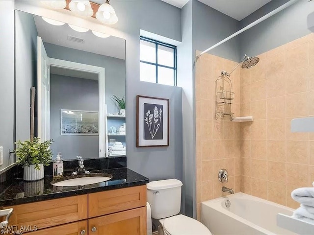 bathroom featuring visible vents, shower / bathing tub combination, vanity, and toilet