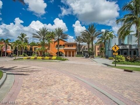 view of street with traffic signs, a residential view, curbs, and sidewalks