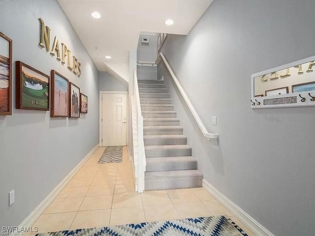 stairway featuring recessed lighting, baseboards, and tile patterned floors