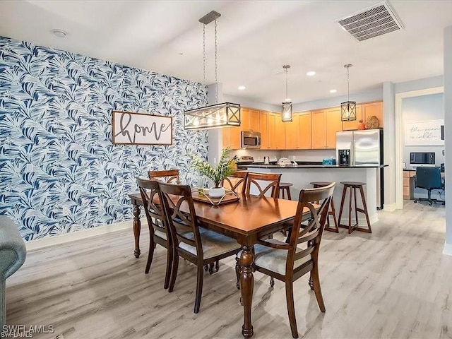 dining space featuring light wood-style floors, recessed lighting, visible vents, and wallpapered walls