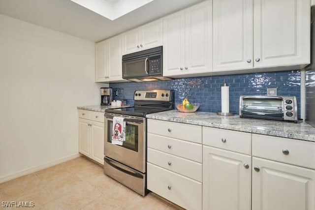 kitchen with black microwave, a toaster, white cabinetry, decorative backsplash, and stainless steel electric range oven