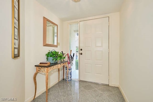 foyer featuring baseboards