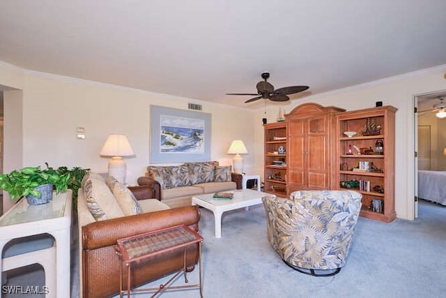 living area with ornamental molding, carpet, visible vents, and a ceiling fan