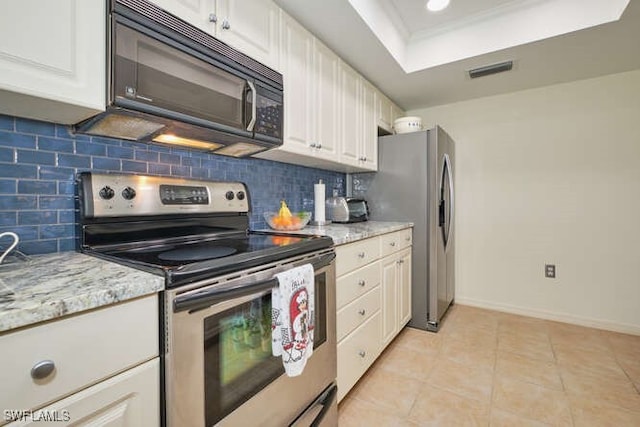 kitchen with light tile patterned floors, visible vents, appliances with stainless steel finishes, backsplash, and a tray ceiling