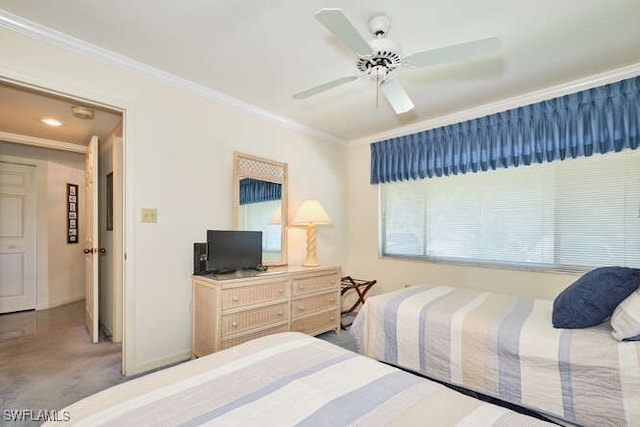 bedroom with ceiling fan, baseboards, crown molding, and carpet flooring