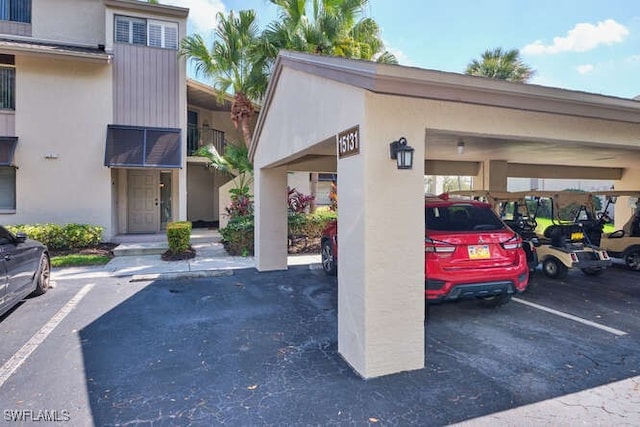 exterior space with covered and uncovered parking