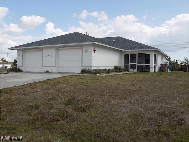 ranch-style house with driveway, a front yard, a sunroom, and stucco siding