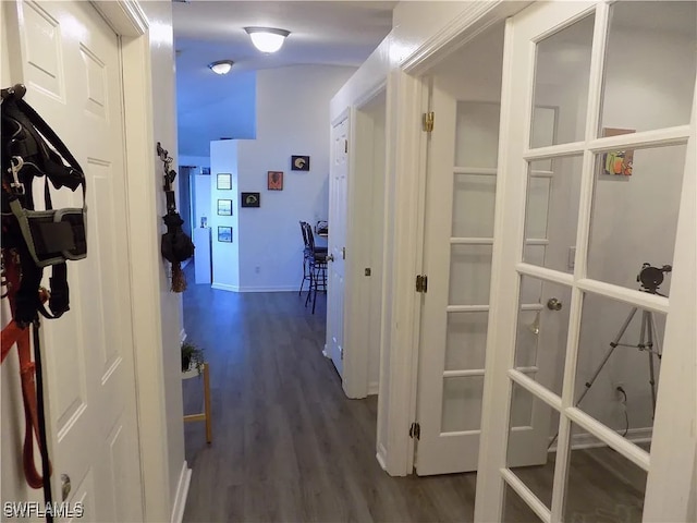 hall with dark wood-style floors and baseboards