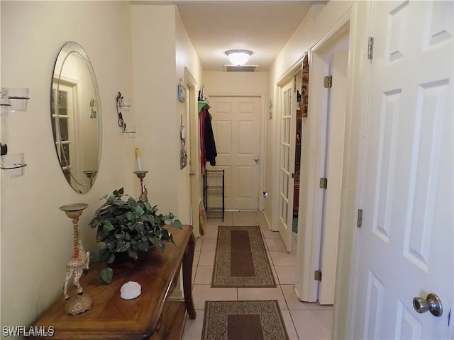 hall with visible vents and light tile patterned flooring