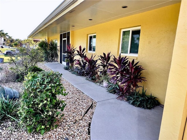 entrance to property with stucco siding