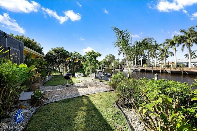 exterior space featuring a lanai and a water view