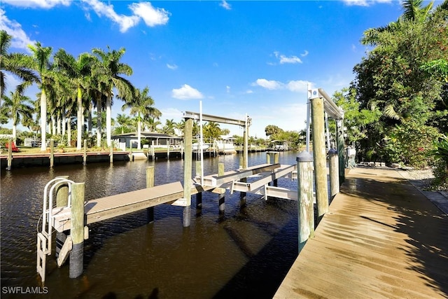 dock area with a water view and boat lift