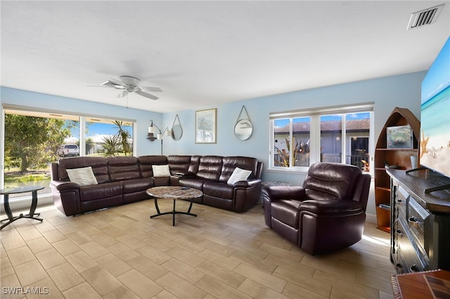 living room with visible vents and a ceiling fan