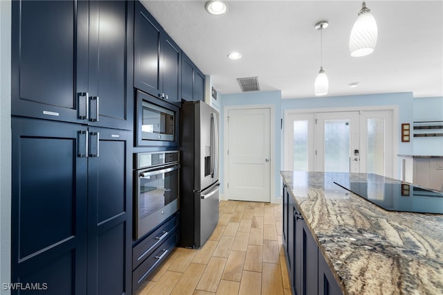 kitchen featuring pendant lighting, stainless steel appliances, visible vents, wood tiled floor, and dark stone countertops