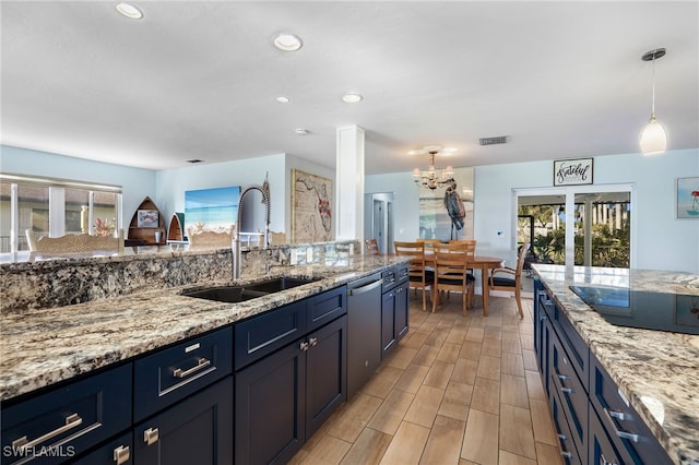 kitchen featuring visible vents, a sink, black electric cooktop, and light stone countertops