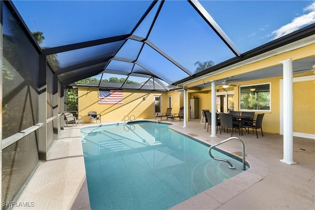 pool featuring outdoor dining space, a lanai, ceiling fan, and a patio